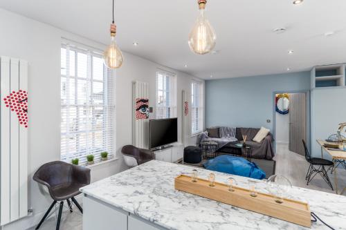 a kitchen and living room with a table and chairs at Nadler House Flat 1 & 2 in Norwich