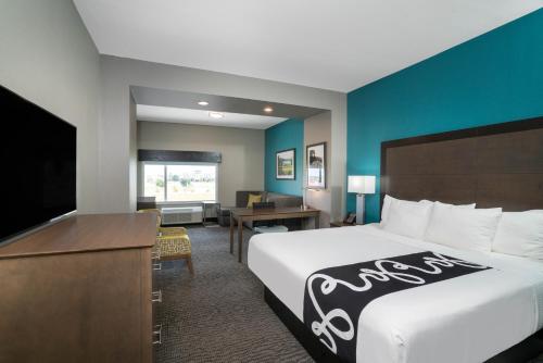 a hotel room with a bed and a flat screen tv at La Quinta by Wyndham West Memphis in West Memphis