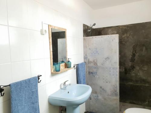 a bathroom with a sink and a mirror at Casa Blu Guesthouse - Casa de Hospedes in Santa Maria