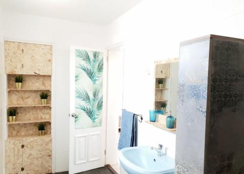 a bathroom with a sink and a mirror at Casa Blu Guesthouse - Casa de Hospedes in Santa Maria