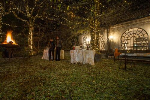 two people standing in front of a table with a fire at Albergo Ristorante Madonnina in Cantello