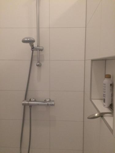 a shower in a bathroom with a glass door at Slapen bij Van-V in Zierikzee