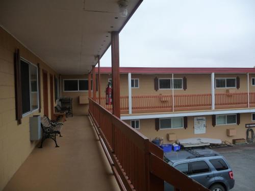 a balcony of a building with a car parked in it at Sun Beach Motel in Osoyoos