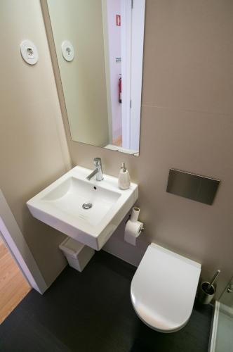 a bathroom with a white sink and a toilet at Change The World Hostels - Coimbra - Almedina in Coimbra