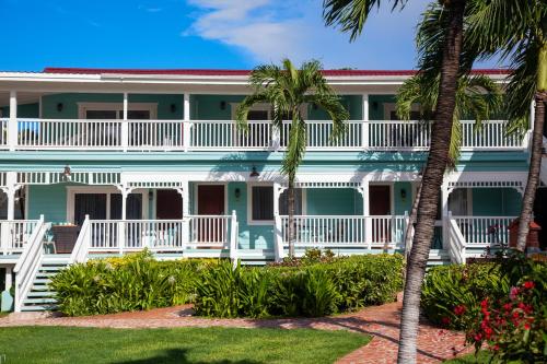a building with palm trees in front of it at Pineapple Beach Club - All Inclusive - Adults Only in Willikies