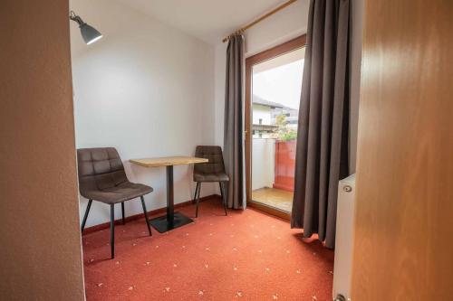 a room with a table and two chairs and a window at Haus Steinbock in Neustift im Stubaital