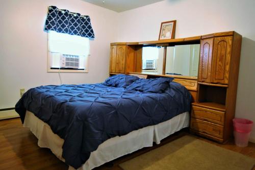a bedroom with a bed and a dresser and a mirror at Marina Vista in Penn Yan