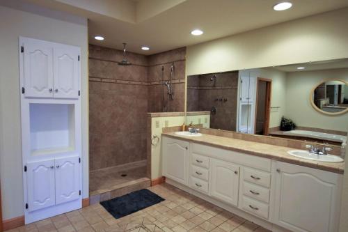 a large bathroom with two sinks and a shower at Marina Vista in Penn Yan