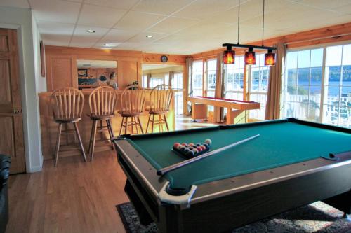 a living room with a pool table and chairs at Marina Vista in Penn Yan