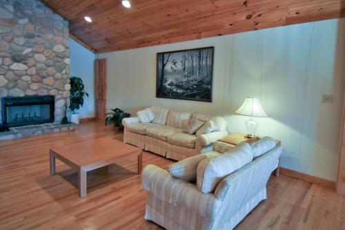 a living room with two couches and a fireplace at Marina Vista in Penn Yan