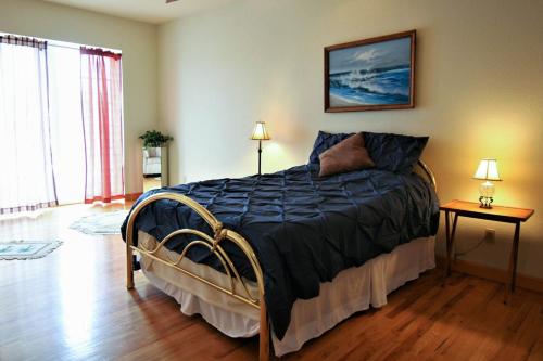 a bedroom with a bed with a blue comforter at Marina Vista in Penn Yan