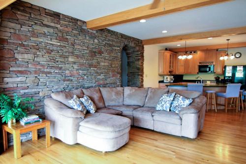 a living room with a couch and a brick wall at Marina Vista in Penn Yan