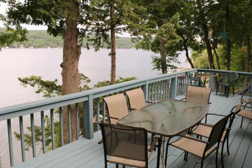 a table and chairs on a deck overlooking the water at QKA View in Penn Yan