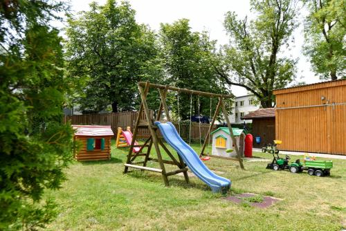 a playground with a slide and play equipment in a yard at Gasthof Kolb in Bayreuth
