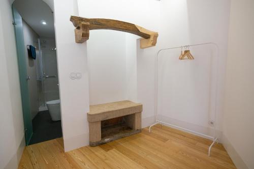 a bathroom with a wooden bench and a shower at Change The World Hostels - Coimbra - Almedina in Coimbra