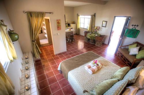 a living room with a bed and a couch at Hotel La Quinta del Sol in Punta Mita