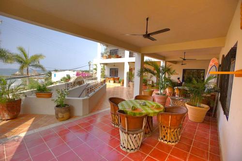 a patio with a table and chairs on a balcony at Hotel La Quinta del Sol in Punta Mita