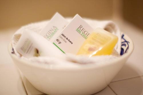 a bowl of food with packets of butter and butter at Hotel La Quinta del Sol in Punta Mita