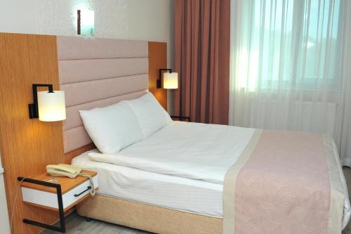 Letto o letti in una camera di Lion City Hotel Ankara