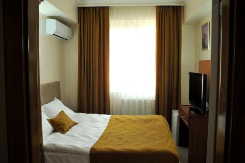 Letto o letti in una camera di Lion City Hotel Ankara