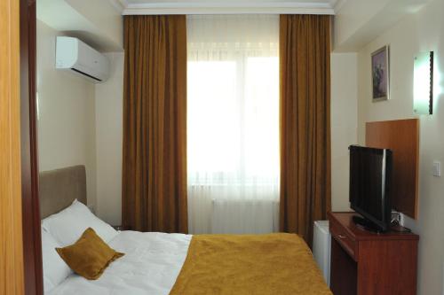 TV o dispositivi per l'intrattenimento presso Lion City Hotel Ankara
