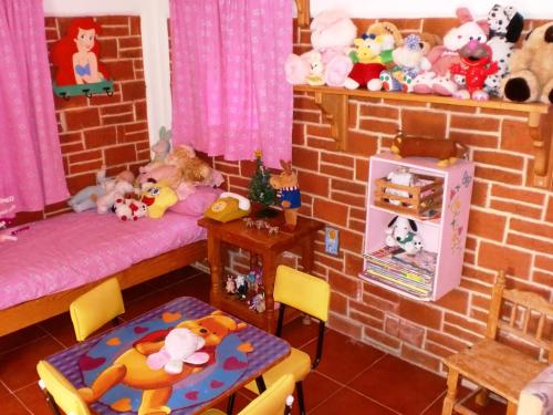 a room with a brick wall with beds and stuffed animals at Hotel Casa de la Luna in San Juan Teotihuacán