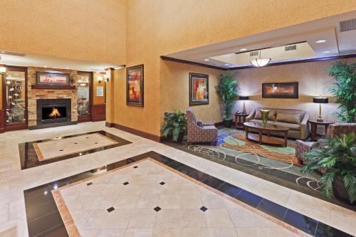 a hotel lobby with a pool table and a fireplace at Holiday Inn Express & Suites Poteau by IHG in Poteau
