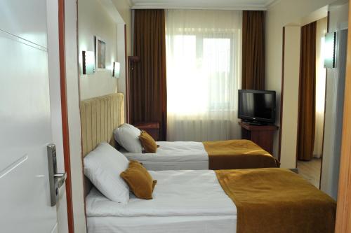 Letto o letti in una camera di Lion City Hotel Ankara