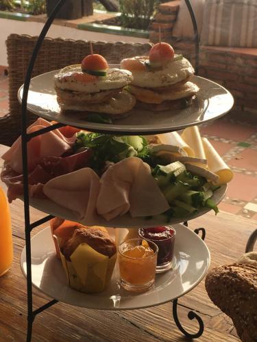 a three tiered plate of food on a table at La Casa del Burro in Nerja