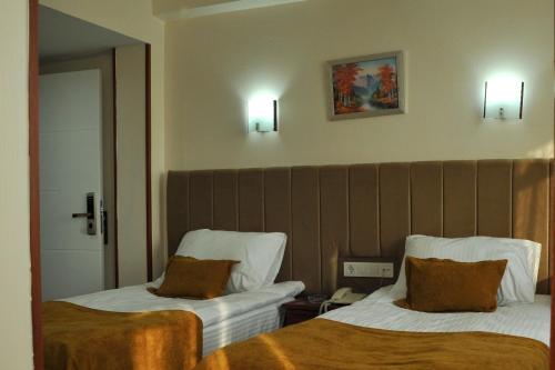 Letto o letti in una camera di Lion City Hotel Ankara