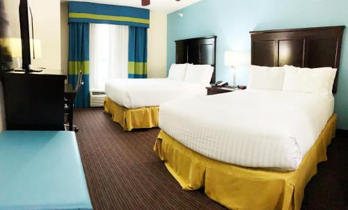 a hotel room with two beds in a room at Holiday Inn Express Hotel & Suites Gainesville by IHG in Gainesville