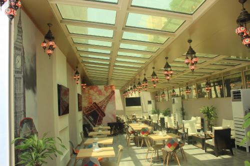 a dining room with tables and chairs and windows at Holiday Inn Al Khobar by IHG in Al Khobar