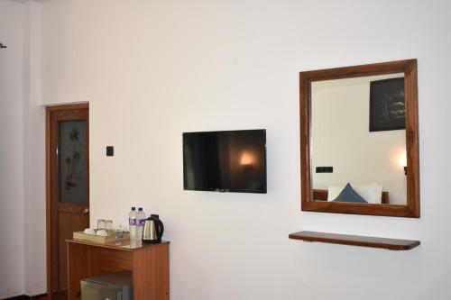a mirror on the wall of a room at Forest Edge Safari Villa in Udawalawe