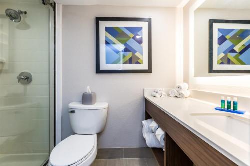 a bathroom with a toilet and a sink and a shower at Holiday Inn Express Exton - Great Valley by IHG in Exton
