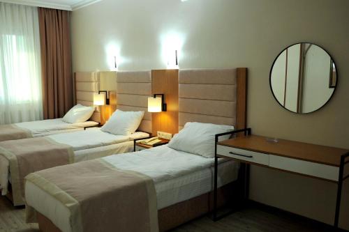 Letto o letti in una camera di Lion City Hotel Ankara