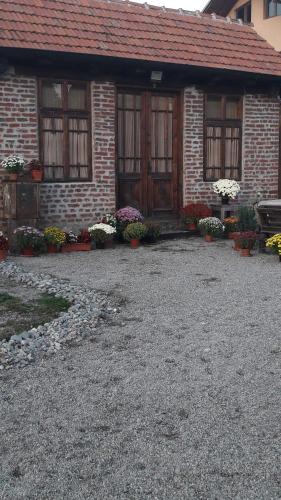 a brick house with flowers in front of it at Old Court in Curtea de Argeş
