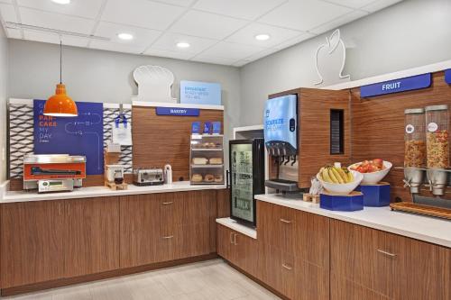 a store with a checkout counter with fruits and vegetables at Holiday Inn Express Exton - Great Valley by IHG in Exton
