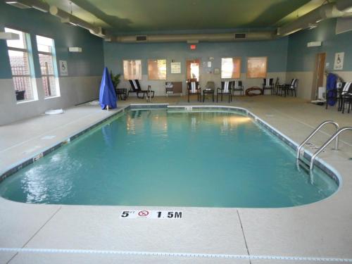 a large swimming pool in a room with tables and chairs at Holiday Inn Express Fairfield, an IHG Hotel in Fairfield