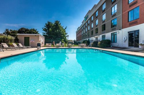 a large blue swimming pool in front of a building at Holiday Inn Express Exton - Great Valley by IHG in Exton