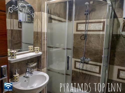 a bathroom with a shower and a sink at Pyramids Top Inn in Cairo