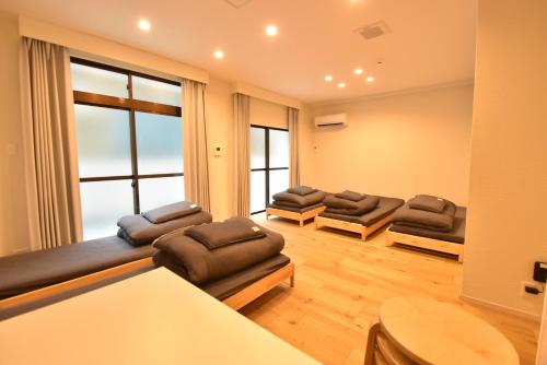 a living room with couches and a large window at Enzo Kyoto Gojo E / Vacation STAY 54295 in Kyoto