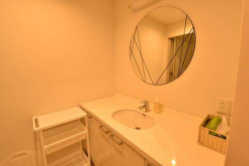 a bathroom with a sink and a mirror at Enzo Kyoto Gojo E / Vacation STAY 54295 in Kyoto