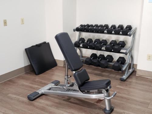 a gym with a chair and a rack of dumbbells at Holiday Inn Express Edgewood-Aberdeen-Bel Air in Edgewood