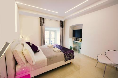 a bedroom with a bed with pillows and a desk at San Pietro Grand Suite in Rome