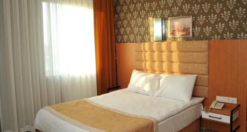 Letto o letti in una camera di Lion City Hotel Ankara