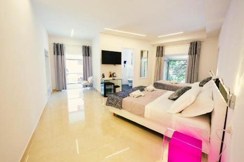 a bedroom with a large bed and a television at San Pietro Grand Suite in Rome