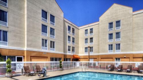 an image of an apartment building with a swimming pool at Holiday Inn Express Greenville by IHG in Greenville