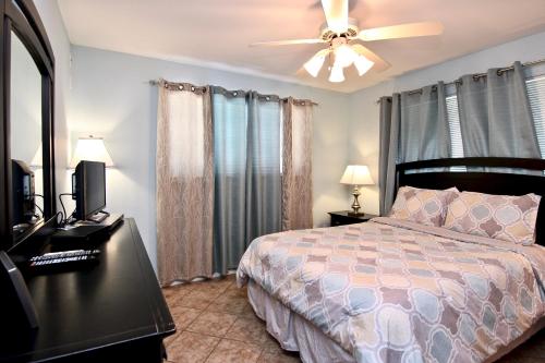 a bedroom with a bed and a ceiling fan at Waterwheel Retreat in New Braunfels