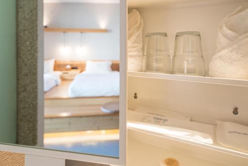 a room with a bed and some glass jars at Zen Tea House Seven Stars Park in Guilin