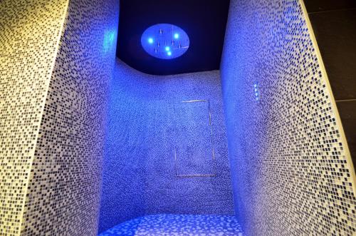 a bathroom with a blue shower with a blue light at Holiday Inn Dijon Toison D'or by IHG in Dijon